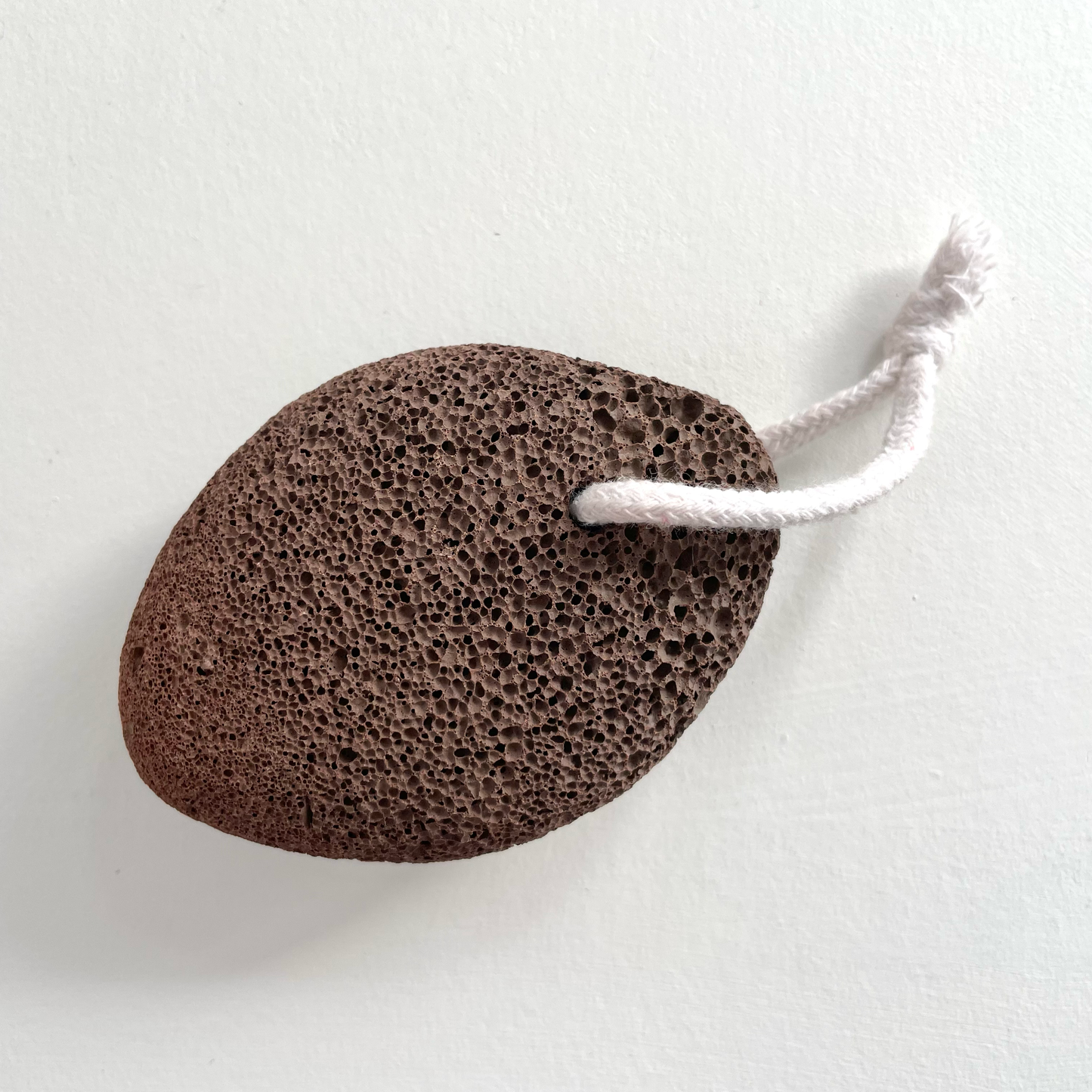 Natural exfoliating lava pumice stone on rope